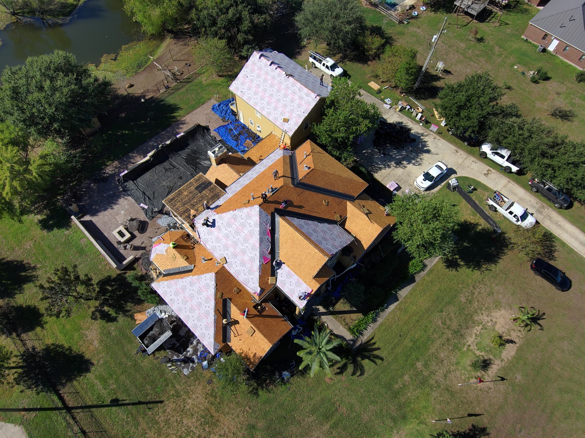 Overhead drone view of new decking and underlayment on a roof replacement