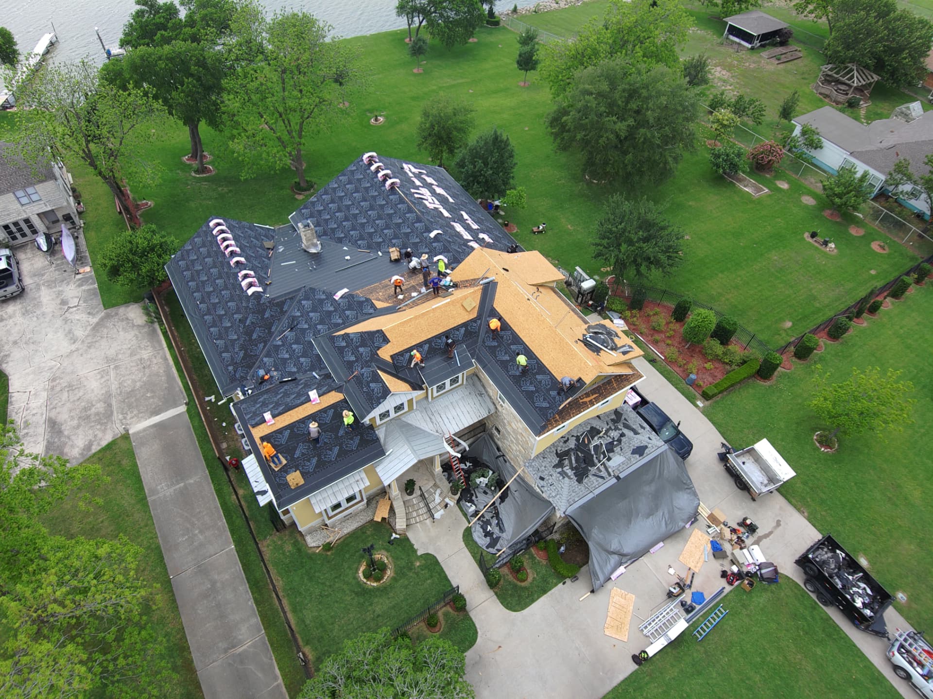 Aerial drone photo of a roof tear-off and decking inspection on a Texas home